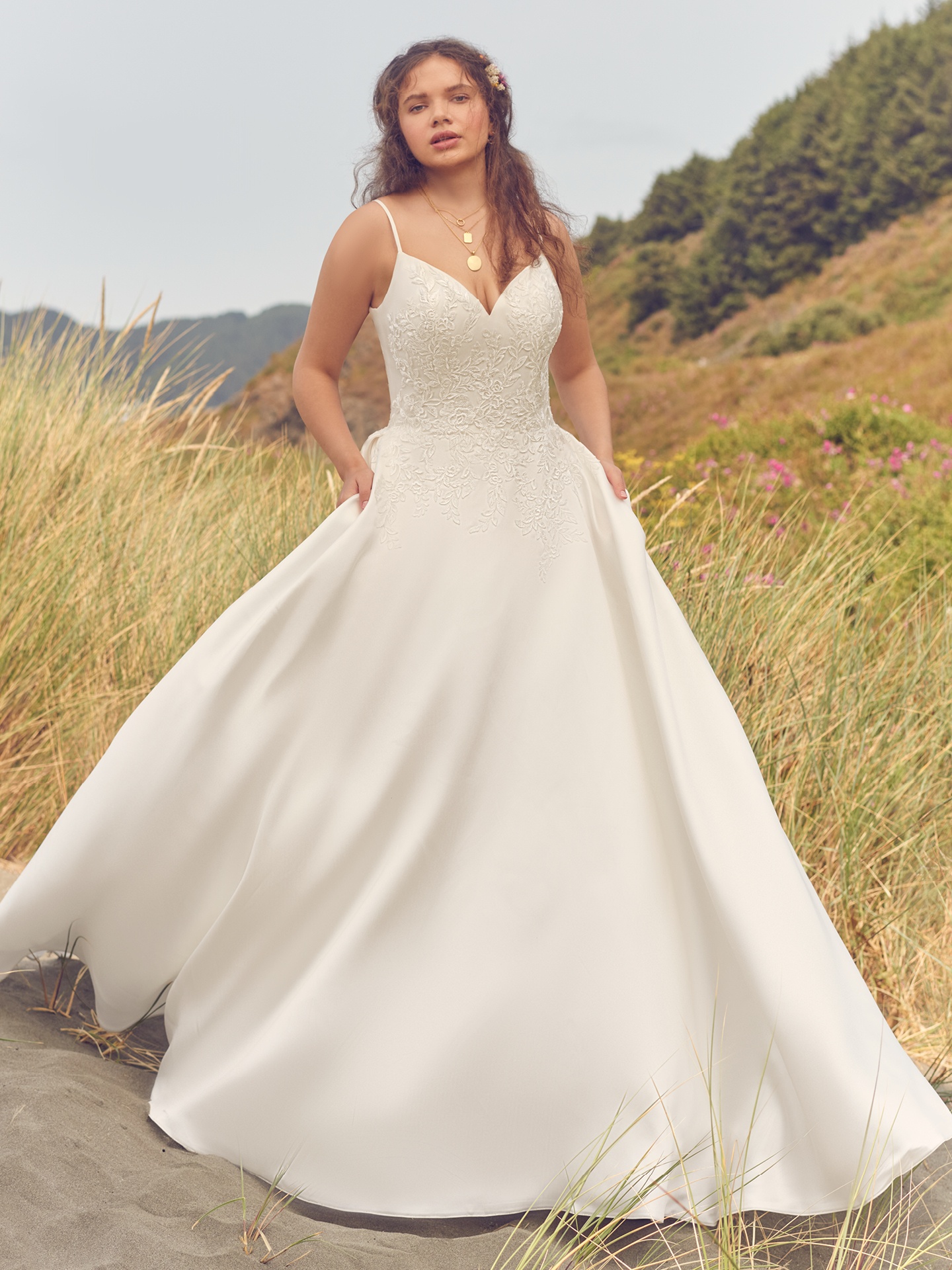 This modern satin ball gown with soft lace appliques is designed for wearability and swooshy sound effects. Available in All ivory sizes UK2-UK30